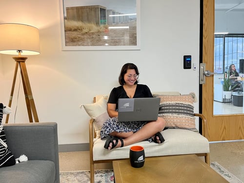 Striveworks team member finds a cozy coffee spot to work in the lobby