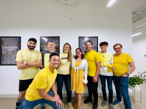 Multiple Striveworks team members twinning in yellow