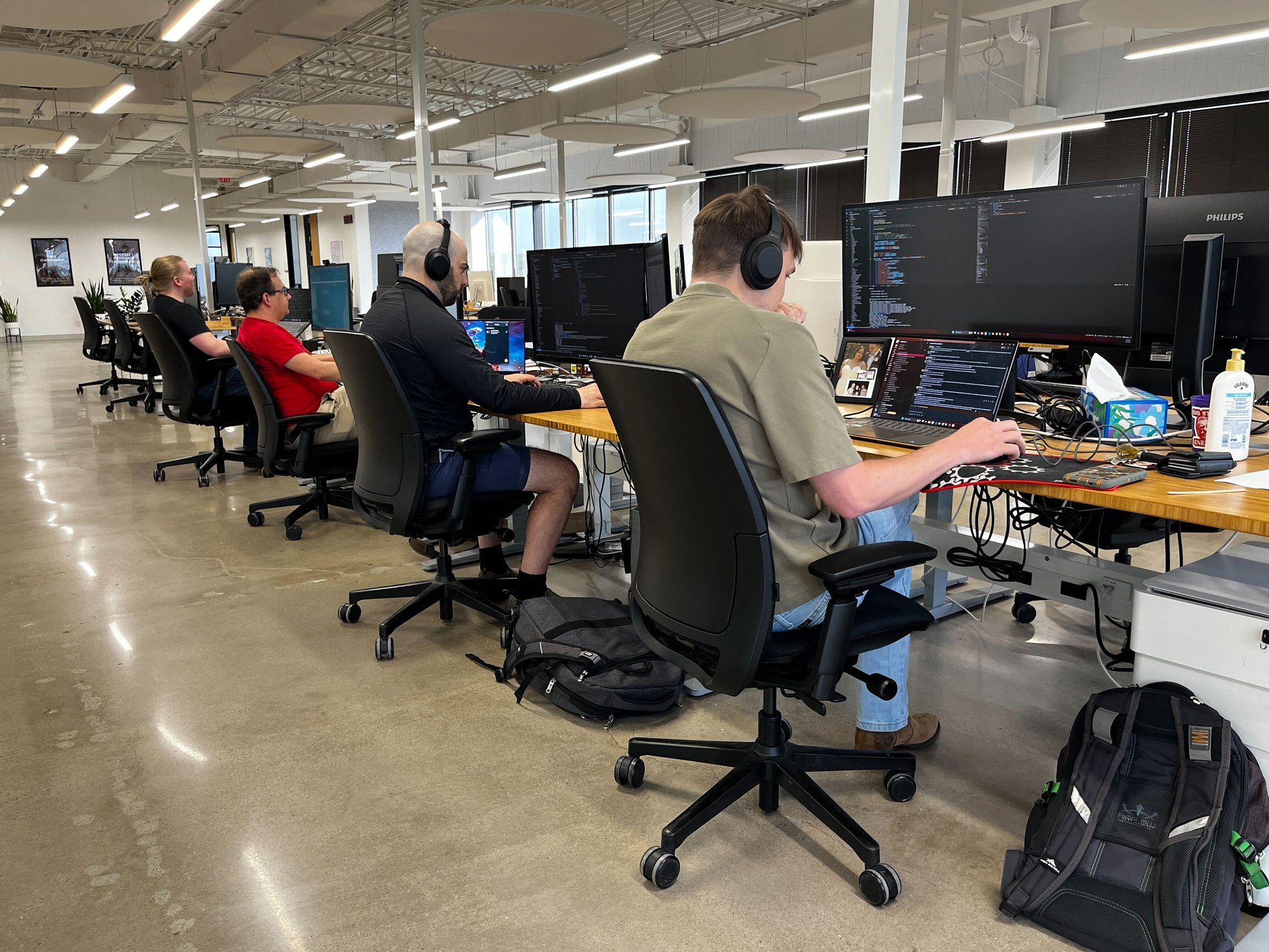 Striveworks team members working at desks in an open office plan
