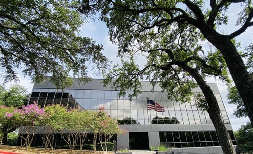 Striveworks HQ building faces extra large American flag flapping in the breeze