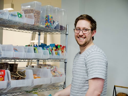 Striveworks team member in front of the fully stocked snack pantry